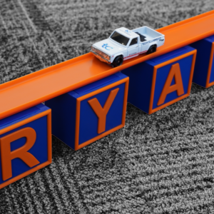 This is a photo of a Personalized Letter Bridge, it is compatible with Hot Wheels and other 1/64 Scale Model Cars.